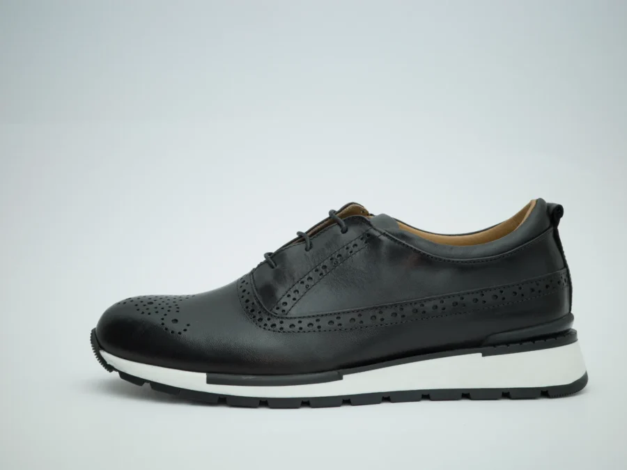 Handcrafted in Italy, this lace-up model reinterprets the timeless brogue design through a clean, modern silhouette. The smooth black calfskin upper is enhanced by precise perforated detailing on the toe and subtle brogue accents along the seams, offering elegance without excess.