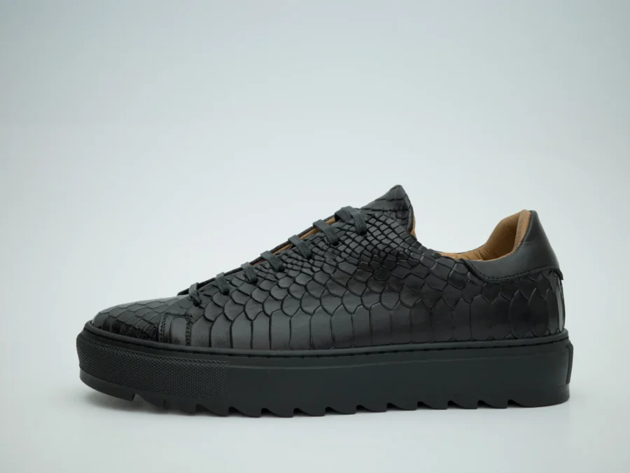 Made in Italy sneaker made of genuine hand-dyed leather in black with natural shades, embellished with an anaconda-print leather upper that reflects light with elegance, without sacrificing an urban feel.