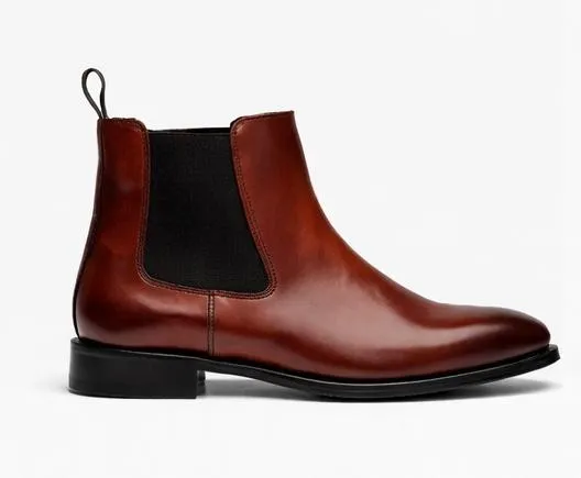 Crafted from rich brown leather with a smooth, refined finish, this Chelsea boot offers timeless style with everyday versatility. The sleek ankle-high profile features elastic side panels for easy slip-on wear, while the rounded toe and clean stitching create a sophisticated, streamlined look.